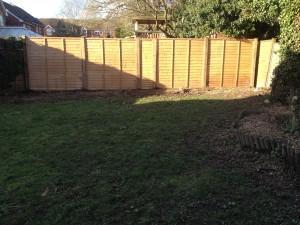 new wooden fence - fence posts and overlap panels