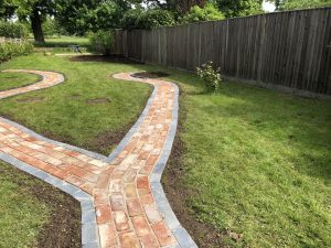 garden pathway made of slate edging stones and reclaimed bricks